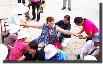 Five masseuses work on Maureen.