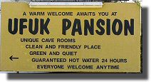 A typical hotel sign advertising "cave rooms" etc.