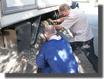 John helps Stephen change a wheel on Mog.